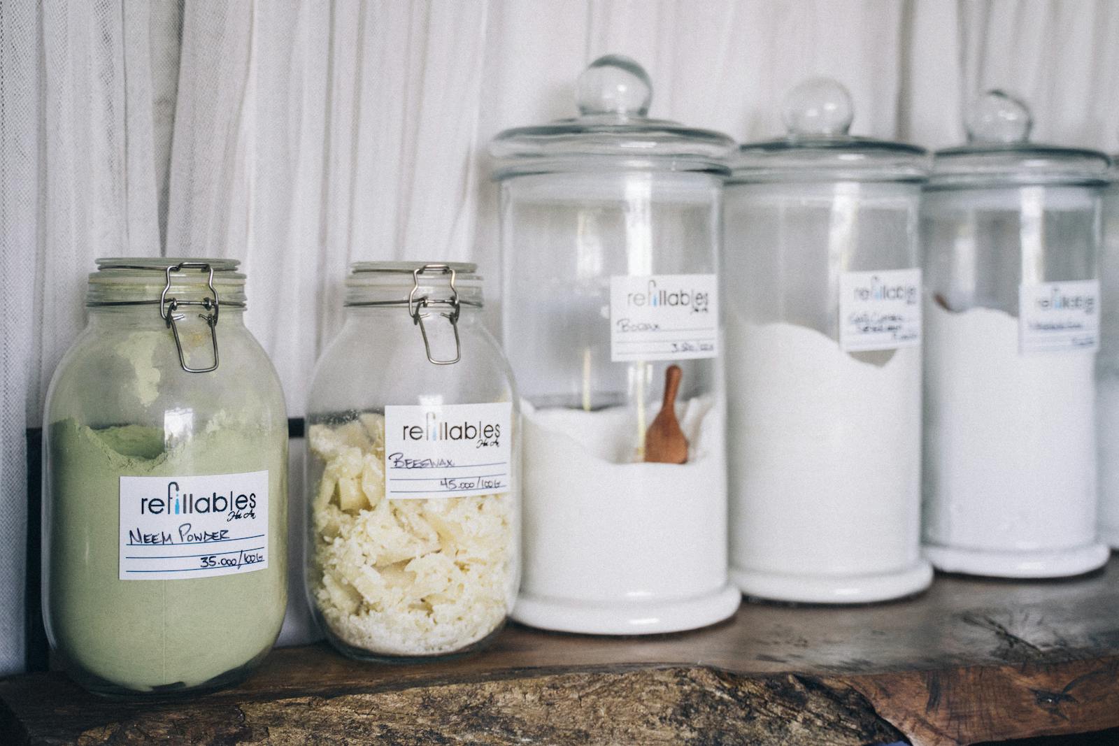 Assorted refillable glass jars containing organic products on display.